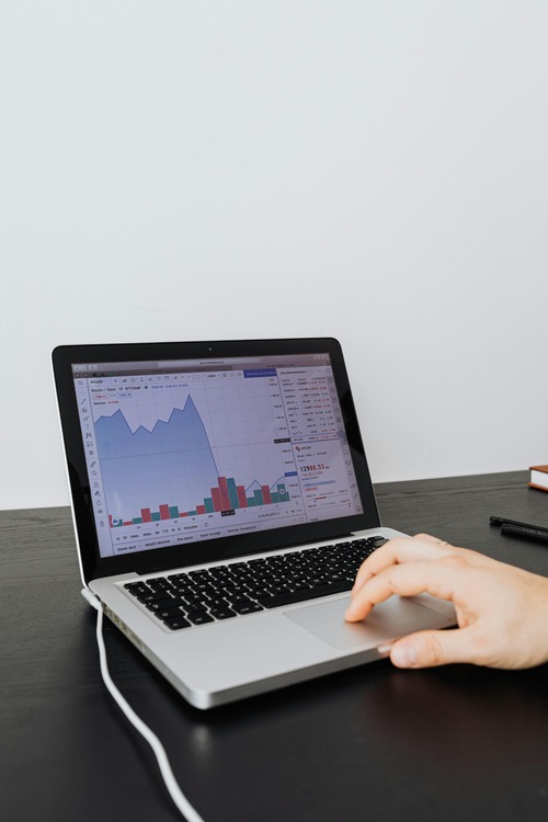 Laptop showing a Bitcoin to USD price chart used for conversion reference