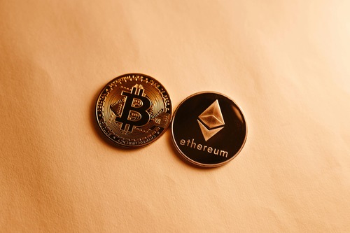 A handful of Bitcoin and Ethereum coins representing an ETH to BTC swap