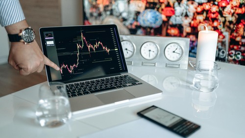 Person checking a Bitcoin price chart on a laptop without an account login screen